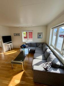 a living room with a couch and a tv at ROOMS by Kåkern Bridge in Sund
