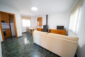 a living room with a white couch and a table at Casa El Pilar in Serón