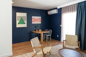 a living room with blue walls and a table and chairs at Mendocino Cove in Fort Bragg