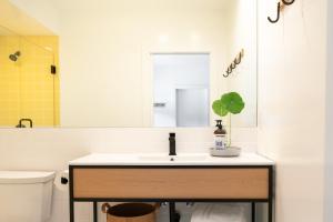 a bathroom with a sink and a toilet and a mirror at Mendocino Cove in Fort Bragg +31 photos
