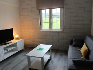a living room with a couch and a coffee table at Casa Tamiván in Muxia