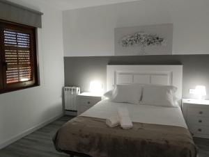 a bedroom with a large bed with two night stands at Casa Tamiván in Muxia
