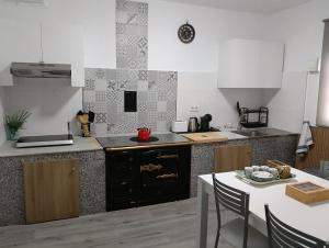 a kitchen with a table and a counter top at Casa Tamiván in Muxia