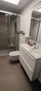 a bathroom with a shower and a toilet and a sink at Domek na górce u Ani in Polanowo +11 photos