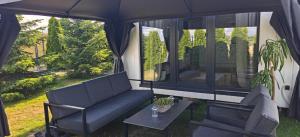 a living room with a couch and a table at Domek na górce u Ani in Polanowo