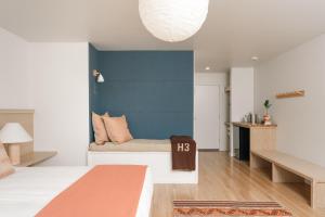 a bedroom with a couch and a blue wall at Mendocino Cove in Fort Bragg