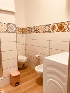 a bathroom with two toilets and a sink at Casa Di Luce Junior Con Parcheggio Privato in Montesilvano