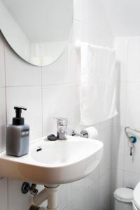 a white bathroom with a sink and a mirror at Casa El Pilar in Serón +27 photos