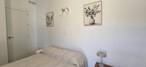 a bedroom with a bed and a vase on the wall at Hostal la Campa in Chiclana de la Frontera