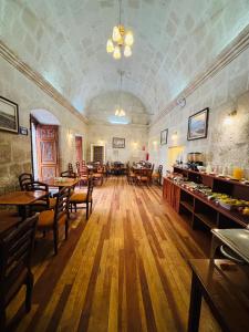 a large room with tables and chairs in a restaurant at Casona Terrace Hotel in Arequipa