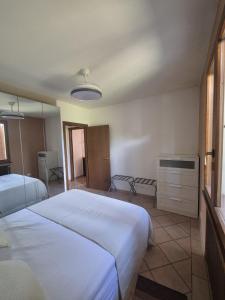 a bedroom with two beds and a mirror at La Casina in Pontedera