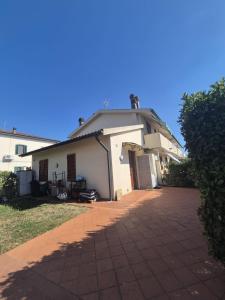 a white house with a driveway in front of it at La Casina in Pontedera