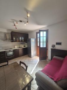 a kitchen with a couch and a table in a room at La Casina in Pontedera +4 photos