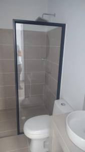 a white bathroom with a toilet and a sink at Hotel Boutique 1801 in San Juan de Rioseco 