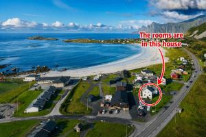 an aerial view of a house on a beach at ROOMS by Ramberg Beach in Ramberg