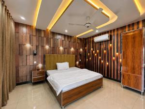 a bedroom with a bed and wooden walls at The Comfy By Hotel Mountain Track in Taranna +16 photos