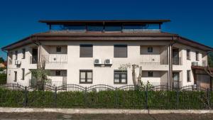 a white building with a fence in front of it at Porto Franco Sulina in Sulina