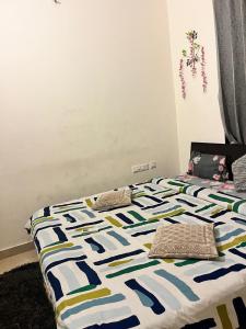 a bed with pillows on it in a bedroom at Trydan room stay in Chengalpattu