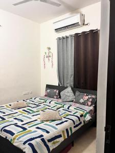 a bedroom with a bed with a colorful comforter at Trydan room stay in Chengalpattu