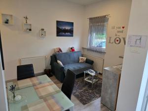 a living room with a couch and a table at apartmani mikek in Domaslovec