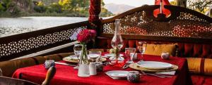 a table with a red table cloth on a boat at Aydos Suites in Dalyan