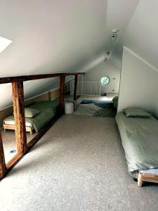 a attic room with two bunk beds in it at Cathedral Apartment Tartu in Tartu