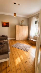 a bedroom with a bed and a wooden floor at Pension zum Ziegenbart in Tangermünde