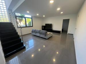 a living room with a couch and a television at Caribe in Platja d'Aro