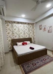 a bedroom with a bed with red bows on it at Pure Bliss 3BHK Stay in Guwahati