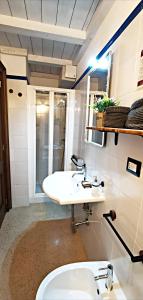 a bathroom with a white sink and a toilet at Casina Raho B&B in Nardò +80 photos