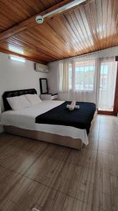 a bedroom with a large bed and a wooden ceiling at Avsa BARAN MOTEL apart in Marmara