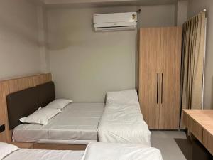 a bedroom with two beds and a air conditioner at hotel a sons in Chittaurgarh