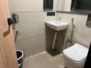 a bathroom with a sink and a toilet at hotel a sons in Chittaurgarh