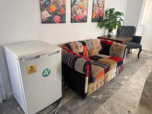 a living room with a couch and a refrigerator at Arolen in Nesebar