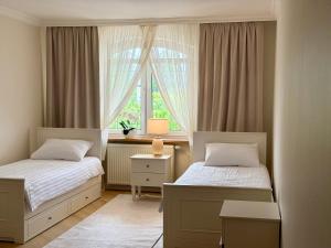 a bedroom with two beds and a window at Hotel Pałac Akropol in Lublin