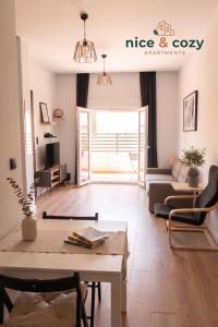 a living room with a couch and a table at Nice and Cozy Apartments in Néa Khilí