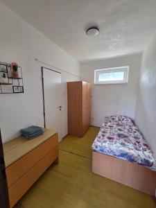 a bedroom with a bed and a cabinet in it at SALEM apartmany in Radava