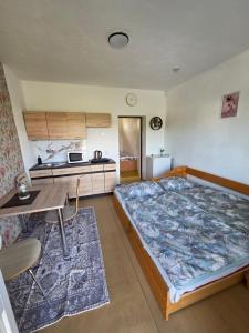 a large bed in a room with a kitchen at SALEM apartmany in Radava