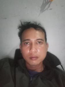 a young man with spiked hair posing for a picture at Hotel in Panenjoan