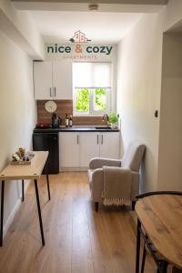 a kitchen with a couch and a table in a room at Nice and Cozy Apartments in Néa Khilí