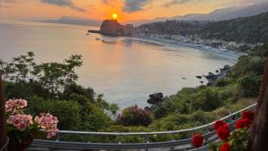 a view of a body of water with the sun setting at Casa Vacanze Morselli in Scilla