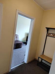an open door into a room with a mirror at SunKiss in Melnragė