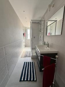 a small bathroom with a sink and a shower at Guglie's Guest House in Livorno