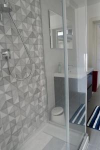 a bathroom with a glass shower with a toilet at Guglie's Guest House in Livorno +2 photos