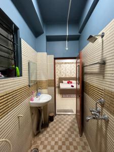 a bathroom with a sink and a bed at Pure Bliss 3BHK Stay in Guwahati +10 photos