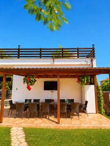 a patio with a table and chairs and a television at Tortuga in Costinesti