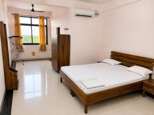 a bedroom with a bed in a room with a window at Bits Pilani Resort in Bagar +14 photos
