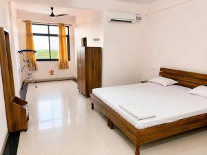 a bedroom with a bed in a room with a window at Bits Pilani Resort in Bagar