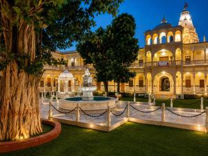 a large building with a fountain in front of it at Bits Pilani Resort in Bagar