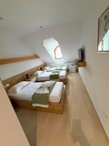 a group of four beds in a room at Jeton Resort in Çerenec i Poshtëm
